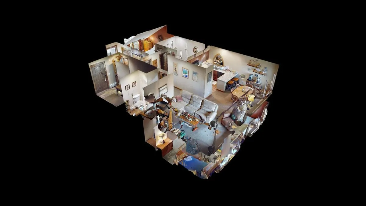 An open-plan living area with a welcoming seating arrangement, partial view of a modern kitchen, and thoughtful decorative touches. The layout is conducive to both relaxation and social interaction, reinforcing the home’s communal spirit.
